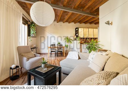 Small Living Room With New Sofa Lamps And Coffee Table Overlooking The Kitchen Area And Wood Beamed 