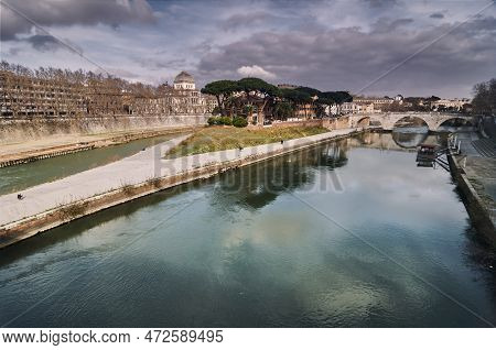 View Of The Tiber Island In Rome With The Tiber River And The City In The Background