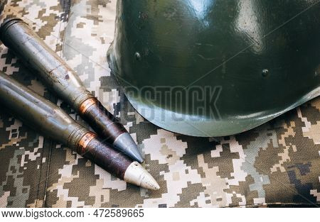 Bullets And Helmet On Khaki Camouflage Background. Lend-lease And Army Concept. Sales Of Weapons And