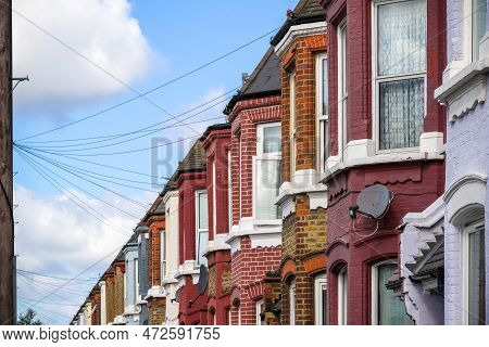 A Row Of Traditional English Terraced Houses Around Kensal Rise In London With Overhead Cable Lines