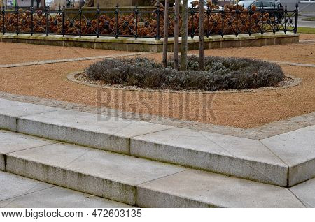 Wire Circular Benches Park Furniture In Winter. Sintered Gravel With The Help Of A Vibrating Roller.