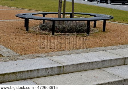 Wire Circular Benches Park Furniture In Winter. Sintered Gravel With The Help Of A Vibrating Roller.