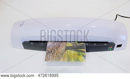 A Machine For Laminating Photos And Documents With Plastic. Desktop White Laminator, Close-up