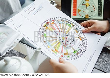 Tver, Russia - February 12, 2023: A Woman At The Table Is Studying A Rave Mandala By Human Design. R