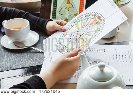 Tver, Russia - February 12, 2023: A Woman At The Table Is Studying A Rave Mandala By Human Design. R