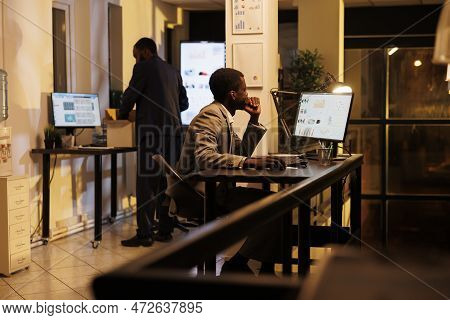 Executive Manager Analyzing Marketing Report On Computer, Checking Financial Graphs Report While Wor