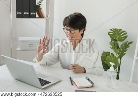 Mature Business Woman Talking About Sale Report In Video Conference. Female Using Laptop Online Meet