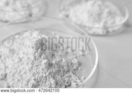Petri Dishes With Calcium Carbonate Powder On White Table, Closeup