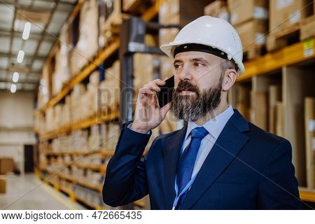 Manager Woman In Suit Calling In A Waehouse.