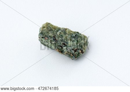 Rock With Peridot Olivine Mineral, White Background. Close-up.