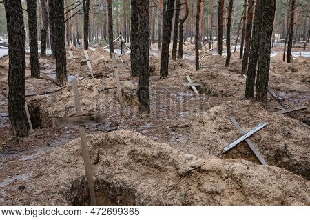 Izium, Ukraine - Mar. 03, 2023: Crosses Are Seen At A Forest Grave Site After An Exhumation In The T