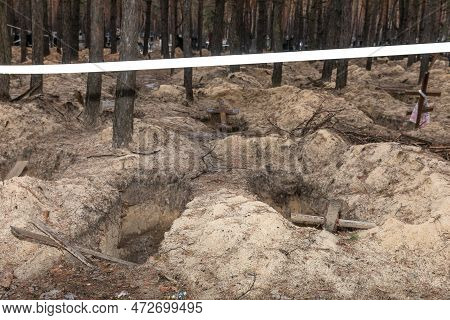 Izium, Ukraine - Mar. 03, 2023: Crosses Are Seen At A Forest Grave Site After An Exhumation In The T