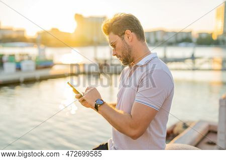 Man Chatting On Phone On The Street. Handsome Confident Man Talking On Phone Outside. Business Phone