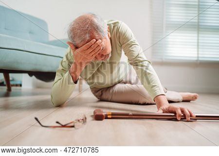 Asian Senior Man Falling On The Ground With Walker In Living Room At Home. Elderly Older Mature Male