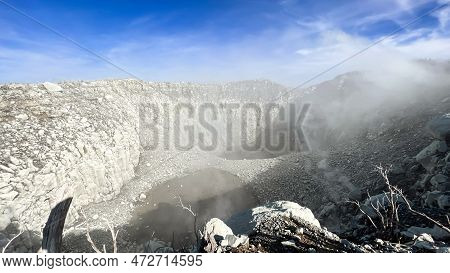 Seeing The Inside Of A Volcano Crater With Smoke In East Java, Indonesia. Aerial View Of Volcano Cra