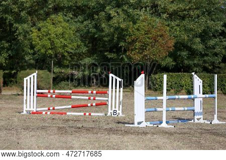 Show Jumping Poles Obstacles, Barriers, Waiting For Riders On Show Jumping Training. Horse Obstacle 
