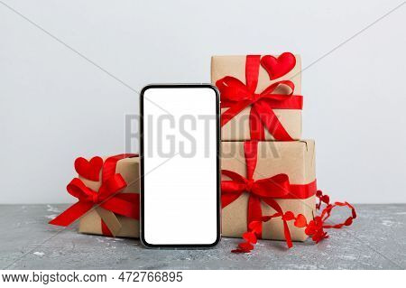 Mobile Phone With Blank Screen On Colored Background With Hearts, Calendar And Gift Box, Valentine D