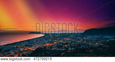 Terracina, Italy. Top View Skyline Cityscape City In Evening Sunset. City Illuminations. Amazing Sun