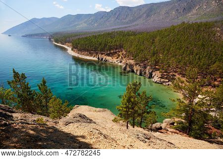 Beautiful Summer Seascape. Turquoise Color Of Lake Water, Mountains Covered With Forest. Wild Nature