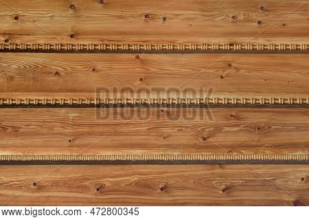 Background Of A Wooden Wall With Traditional Wood Wool Braided Sealing In Traditional Podhale Style 