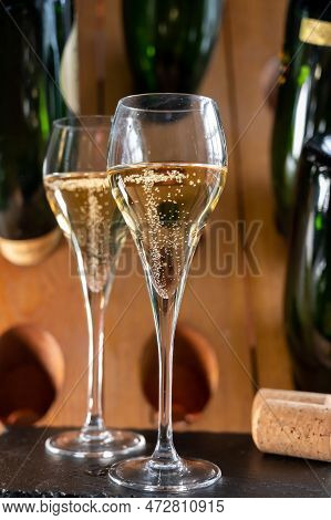 Glasses Of Sparkling White Wine Champagne Or Cava With Bubbles And Classic Wooden Champagne Pupitre