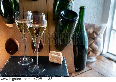 Glasses Of Sparkling White Wine Champagne Or Cava With Bubbles And Classic Wooden Champagne Pupitre