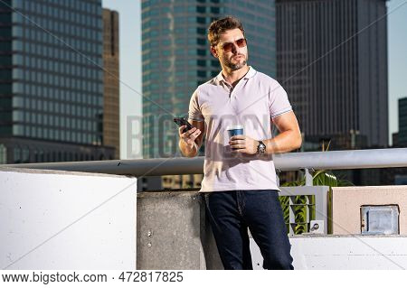 Urban Style Guy Chatting On Phone In Tampa City. Portrait Of Attractive Man With Casual Clothes Talk