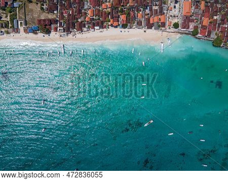 Aerial Shoreline View Of Jungutbatu Beach At Nusa Lembongan With Tourist Speedboat Anchored. One Of 