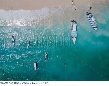Aerial Shoreline View Of Jungutbatu Beach At Nusa Lembongan With Tourist Speedboat Anchored. One Of 