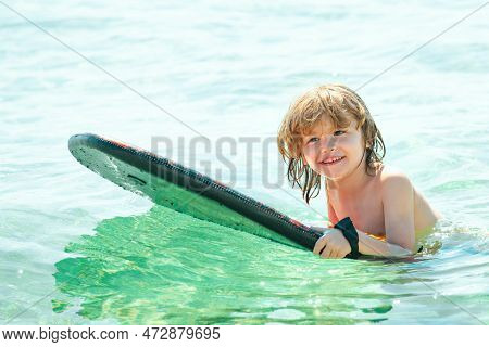 Kid Serfer. Catch The Wave. Extreme Sport Activity. Happy Child Playing In Th Sea Water.
