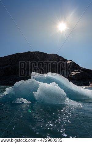 Chunk Of Glacier Ice Lit By Rising Sun Folgefonna Glacier Mosevatnet Lake, Norway
