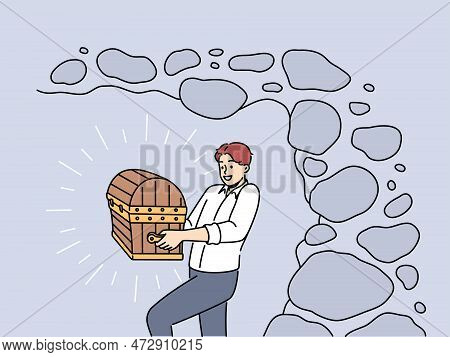 Smiling Businessman With Chest In Hands Excited With Finding Treasure. Happy Man With Wooden Case Or