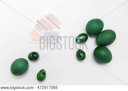 Dyestuff, Colorant In Paper Bag, Package For Coloring Easter Eggs On White Background, Green Painted