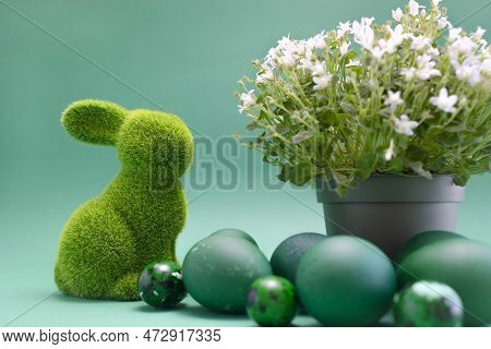 Closeup Easter Green Bunny, Rabbit With Blue Colored Chicken Quail Eggs On Blue Background. White Sp