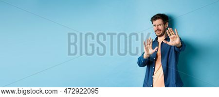 Guy Cringe From Something Disgusting Or Embarrasssing, Stretching Out Hands And Asking To Stop, Grim