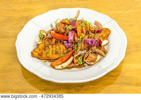 Tenderloin Taco Cooked With Peruvian Recipe Of Vegetables And Red Onions Sautéed With Soy Sauce On A