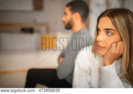 Sad Offended International Millennial Couple Think About Divorce After Quarrel In Living Room Interi