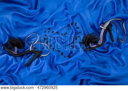 High Heel Shoes  On A Blue Background
