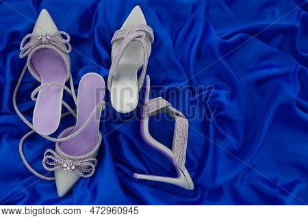 High Heel Shoes  On A Blue Background