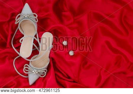 High Heel Shoes  On A Red Background