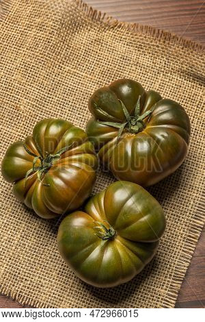 Image Of Stupendous Ripe Tomatoes Of The Sweet Mamarlade Variety On Brown Burlap Cloth And Everythin