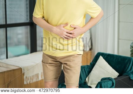 Stomach Ache, Man With Abdominal Pain Suffering At Home