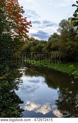 Autumn Foliage Is Reflected In The River. Riverside Environmnet Of Autumn River.