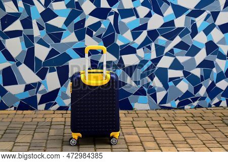 Suitcase Near Hotel, Hostel House. Blue Yellow Travel Suitcase For Vacation Holidays Weekends Travel