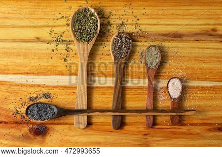 Guayacan Wood Background And Wooden Spoons With Condiments