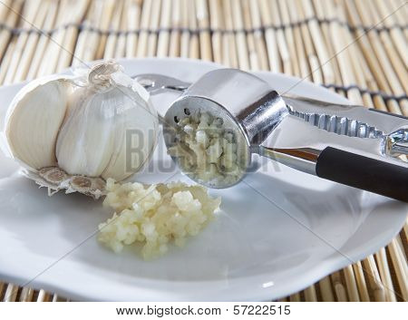 Fresh Garlic Crushed By Garlic Crusher On White Dish On Kitchen Table Top Use For Food  Spice And In