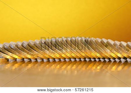 Coins Lying On The Golden Surface With A Golden Background
