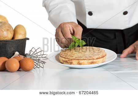 Chef Decorating A Potato Omelette
