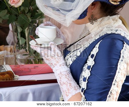 Beautiful vintage woman with cup of tea