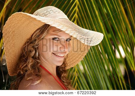 Portrait Of Woman With Straw Hat At Beach Smiling